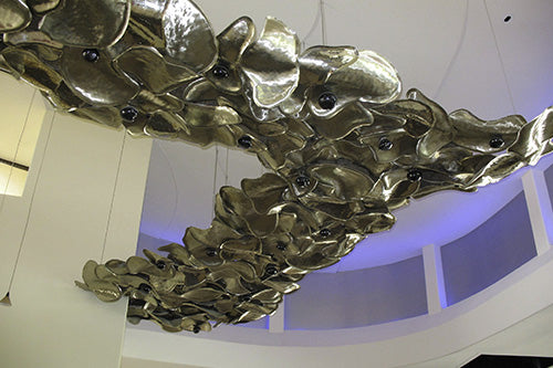 Decorative art metal sculpture suspended from the ceiling